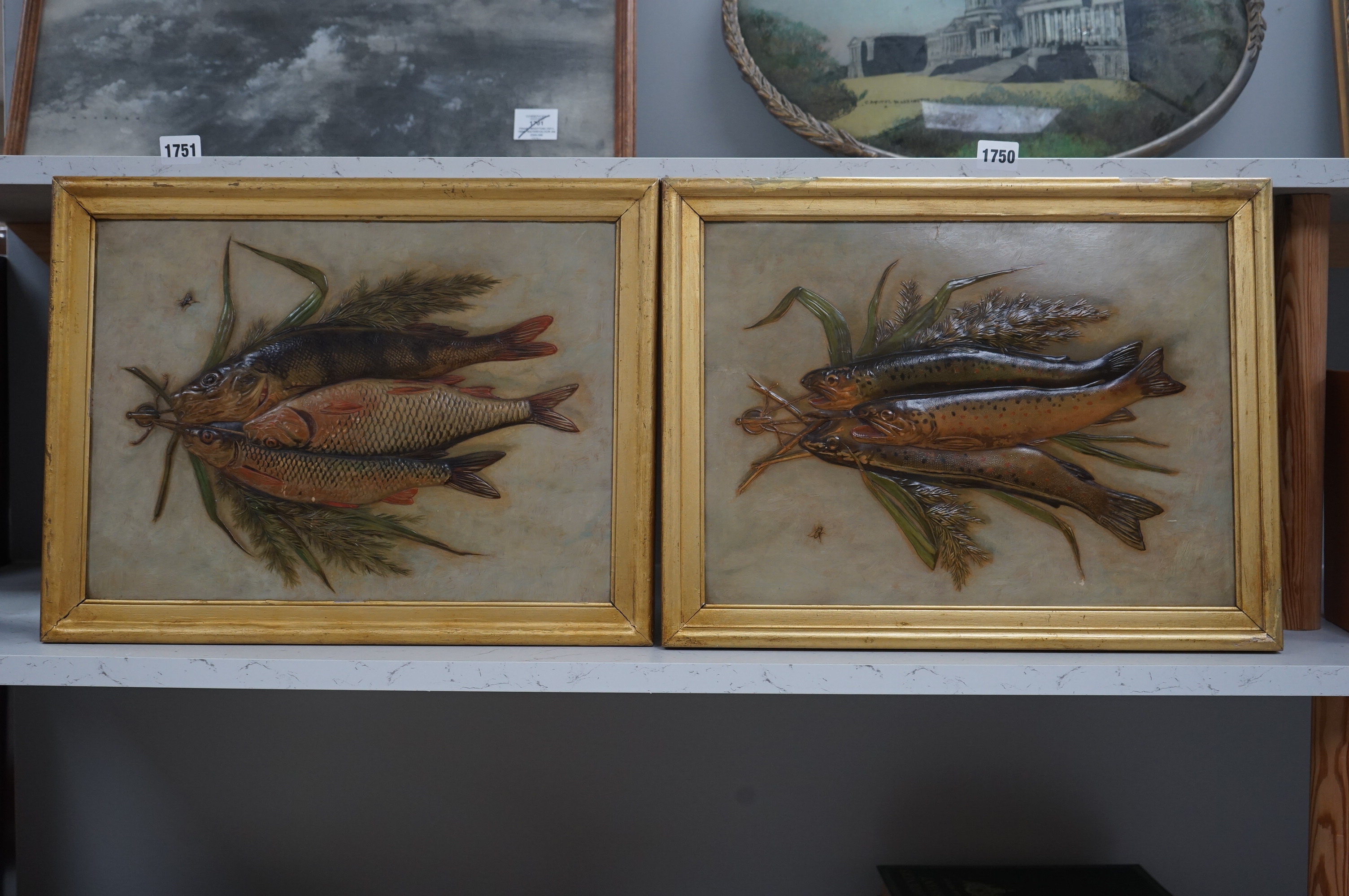 A pair of framed decorative relief 'fish' paintings. 39.5cm wide x 29cm high. Condition - some gilding worn on frames, minor scratches to paintings